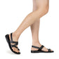 Model wearing Benjamin black, handmade leather sandals with back strap and toe loop