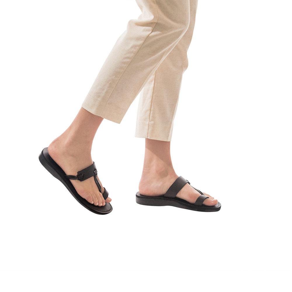 Model wearing David brown, handmade leather slide sandals with toe loop 