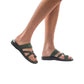 Model wearing The Good Shepherd green, handmade leather slide sandals with toe loop