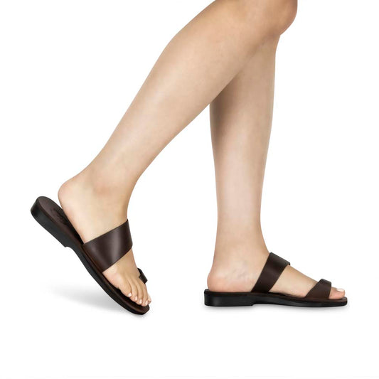 Model wearing Abra brown, handmade leather slide sandals with toe loop