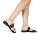 Model wearing Abra brown, handmade leather slide sandals with toe loop