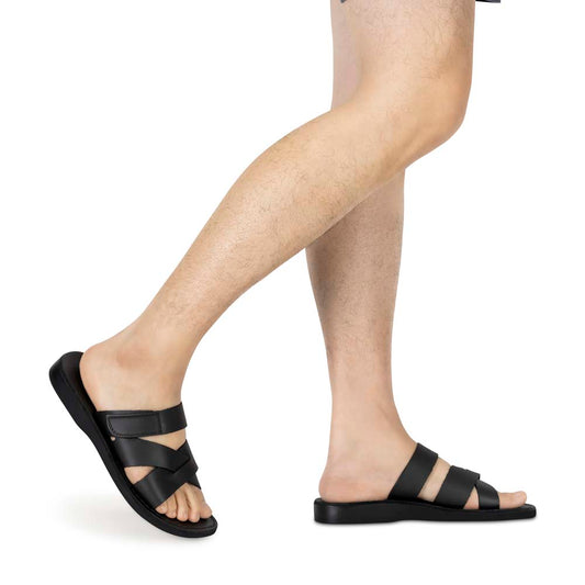 Model wearing Rafael black, handmade leather slide sandals with side velcro strap - Side View