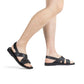 Model wearing Elisha black, handmade leather sandals with back strap