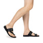 Model wearing Ezra black, handmade leather slide sandals with toe loop