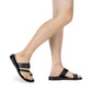 Model wearing Zohar black, handmade leather slide sandals with toe loop