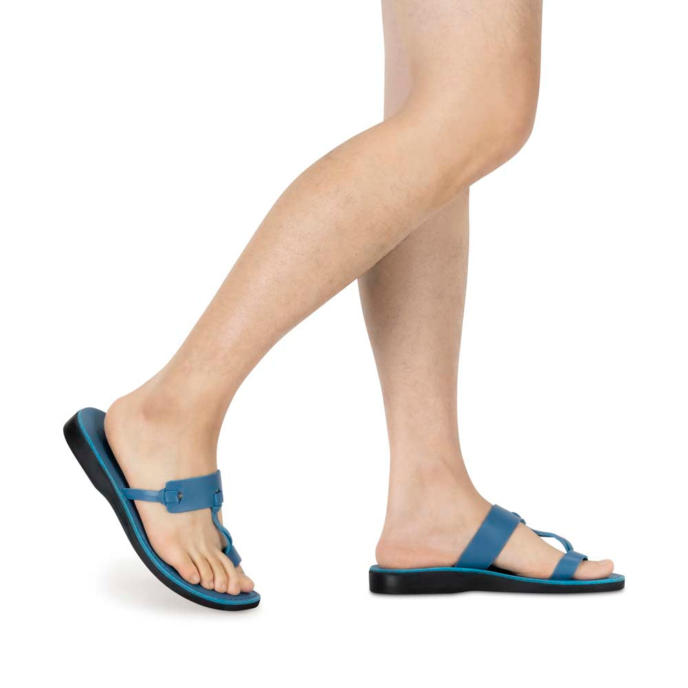 Model wearing David blue, handmade leather slide sandals with toe loop