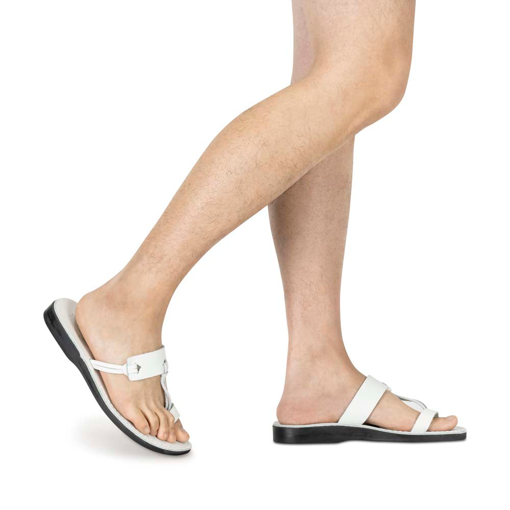 Model wearing David white, handmade leather slide sandals with toe loop