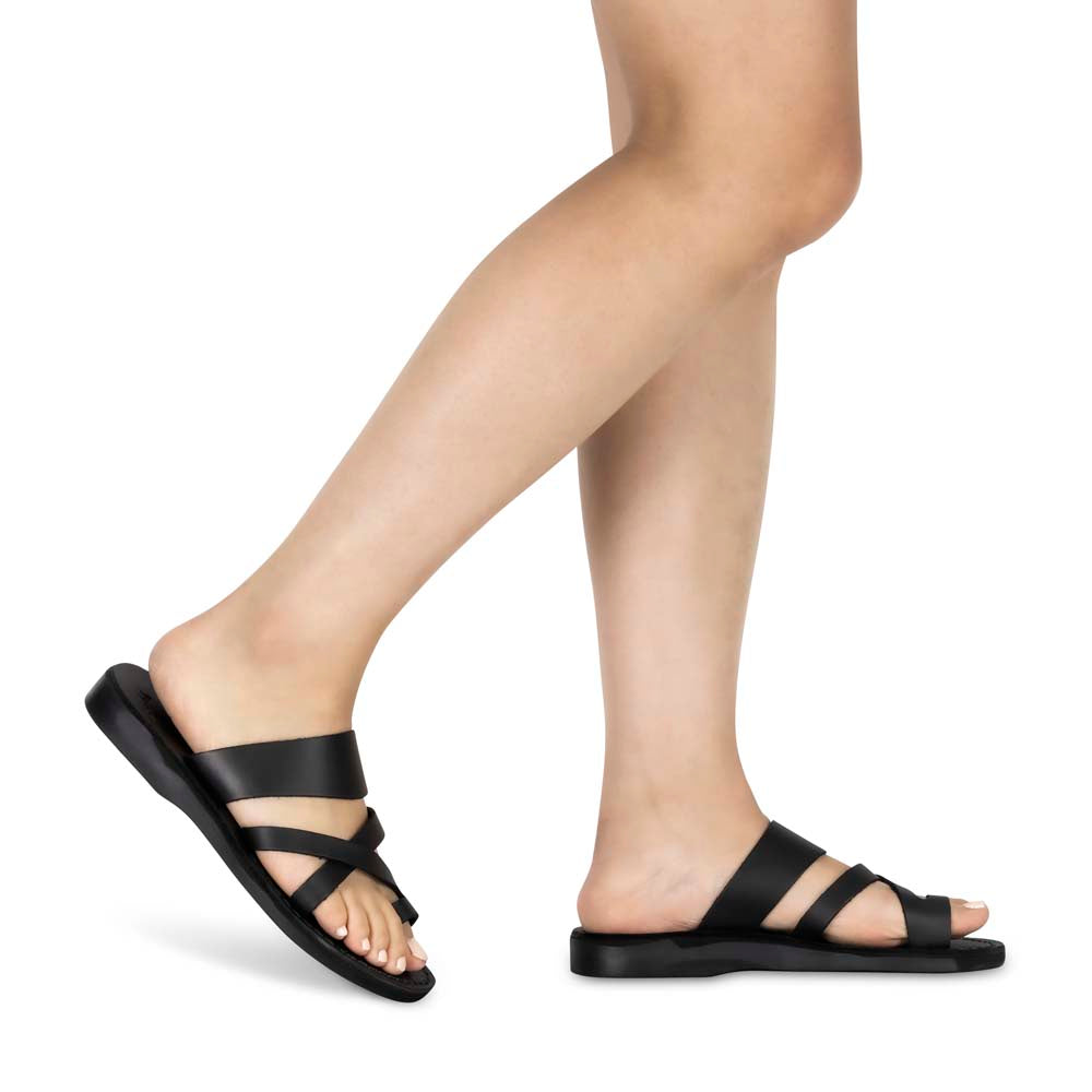 Model wearing The Good Shepherd black, handmade leather slide sandals with toe loop
