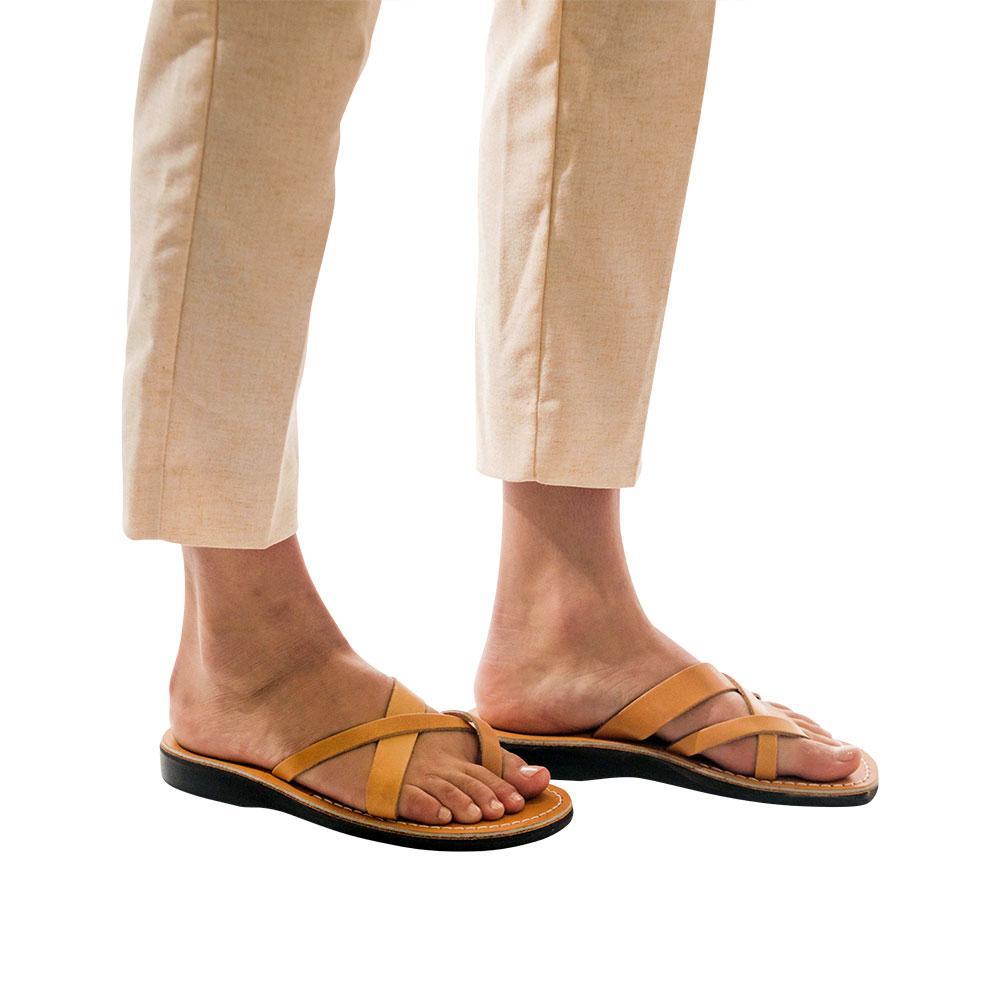 Model wearing Abigail tan, handmade leather slide sandals with toe loop