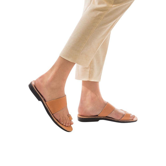 Model wearing Abra tan, handmade leather slide sandals with toe loop 