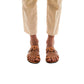 Model wearing Aja tan, handmade leather slide sandals with toe loop 