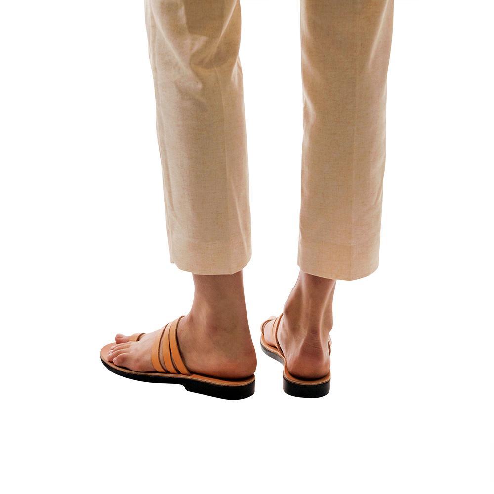Model wearing Angela tan, handmade leather slide sandals with toe loop 