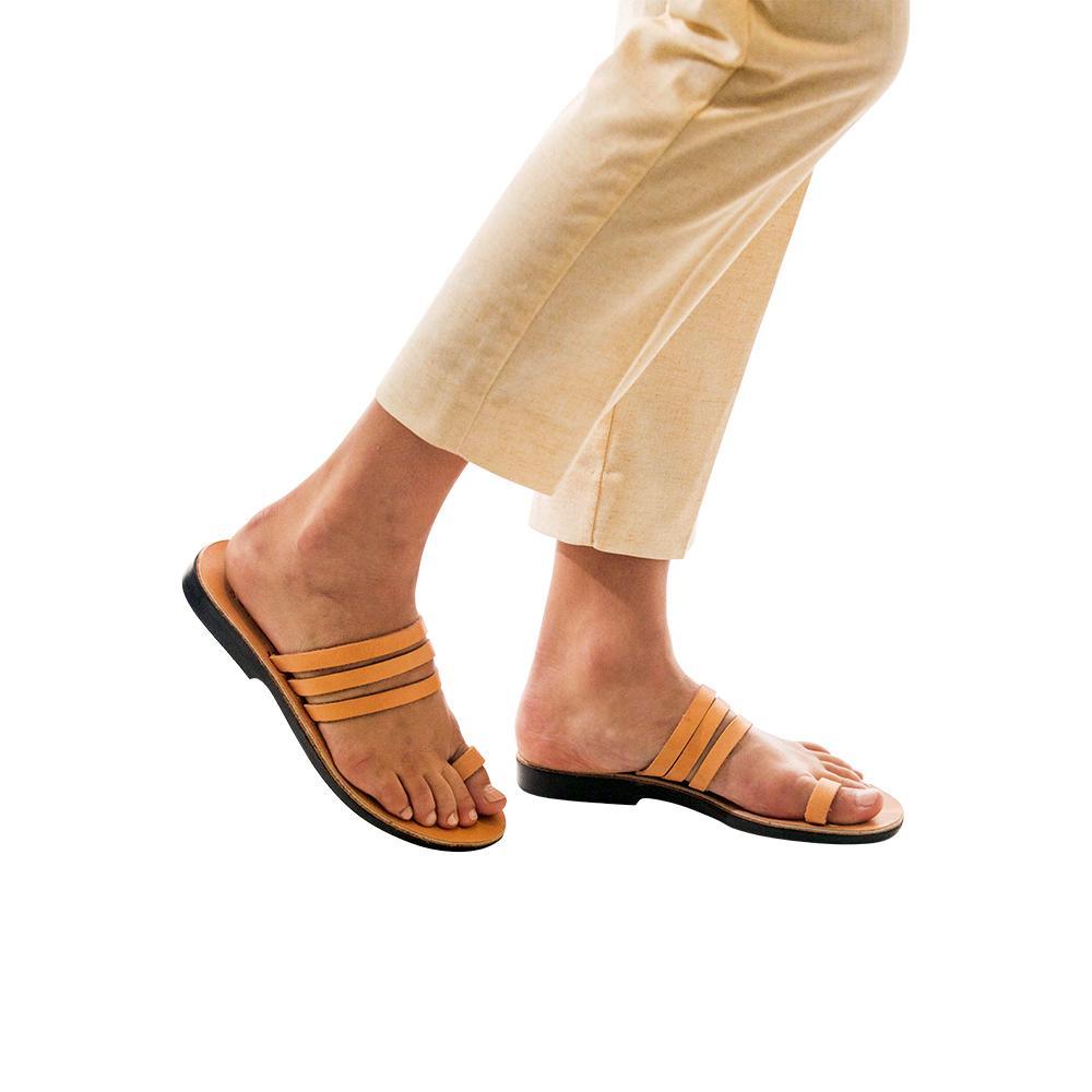 Model wearing Angela tan, handmade leather slide sandals with toe loop 