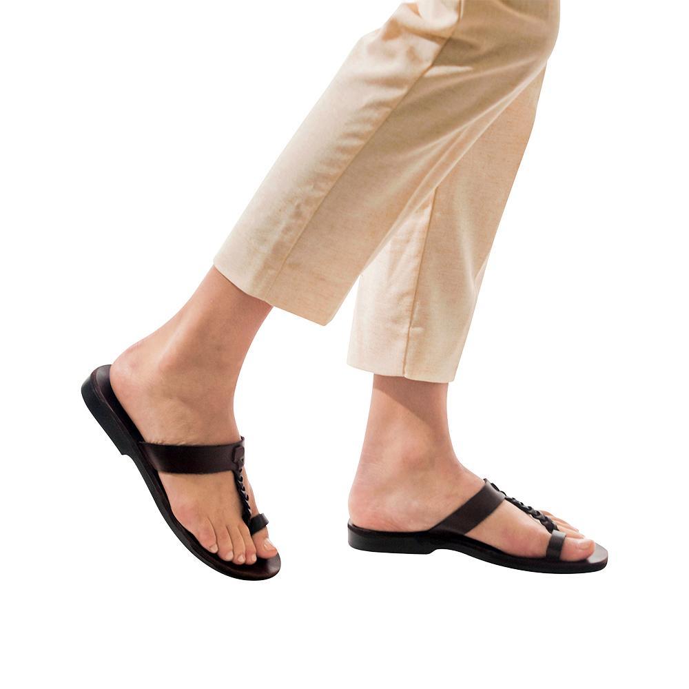 Model wearing Ara brown, handmade leather slide sandals with toe loop 