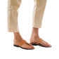 Model wearing Ara tan, handmade leather slide sandals with toe loop 