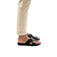 Model wearing Asher black, handmade leather slide sandals with toe loop 