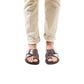 Model wearing Asher brown, handmade leather slide sandals with toe loop 