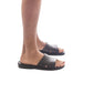 Model wearing Bashan black, handmade leather slide sandals 