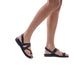 Model  wearing Benjamin black, handmade leather sandals with back strap and toe loop 