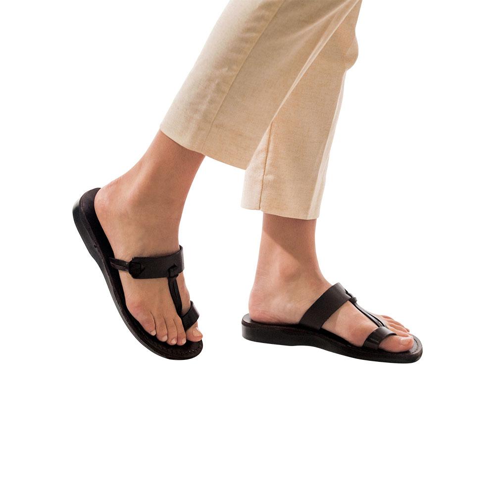 Model wearing David black, handmade leather slide sandals with toe loop 