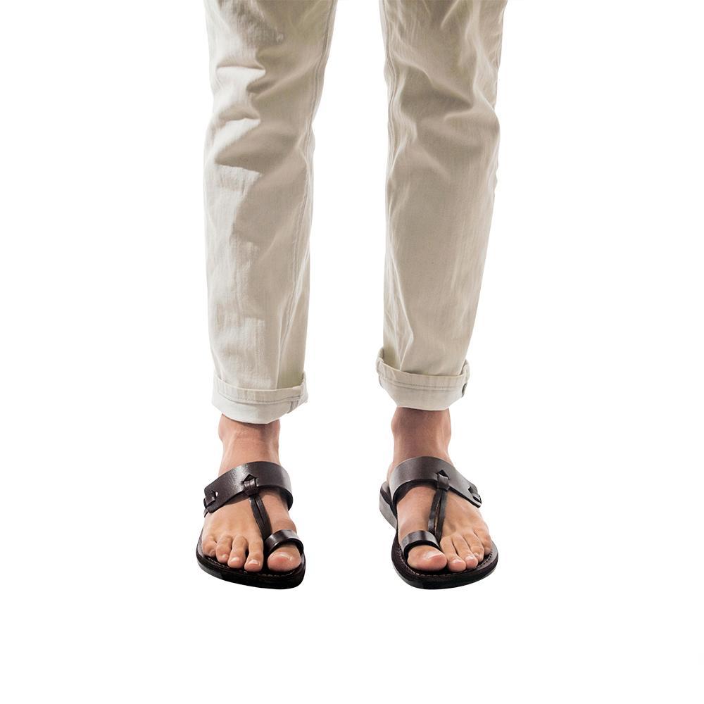 Model wearing David brown, handmade leather slide sandals with toe loop