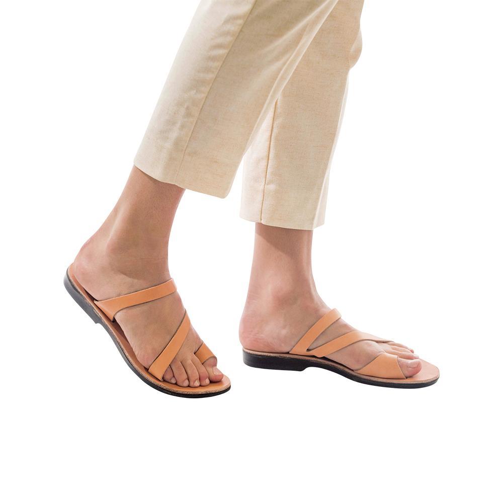 Model wearing Noah tan, handmade leather slide sandals with toe loop 