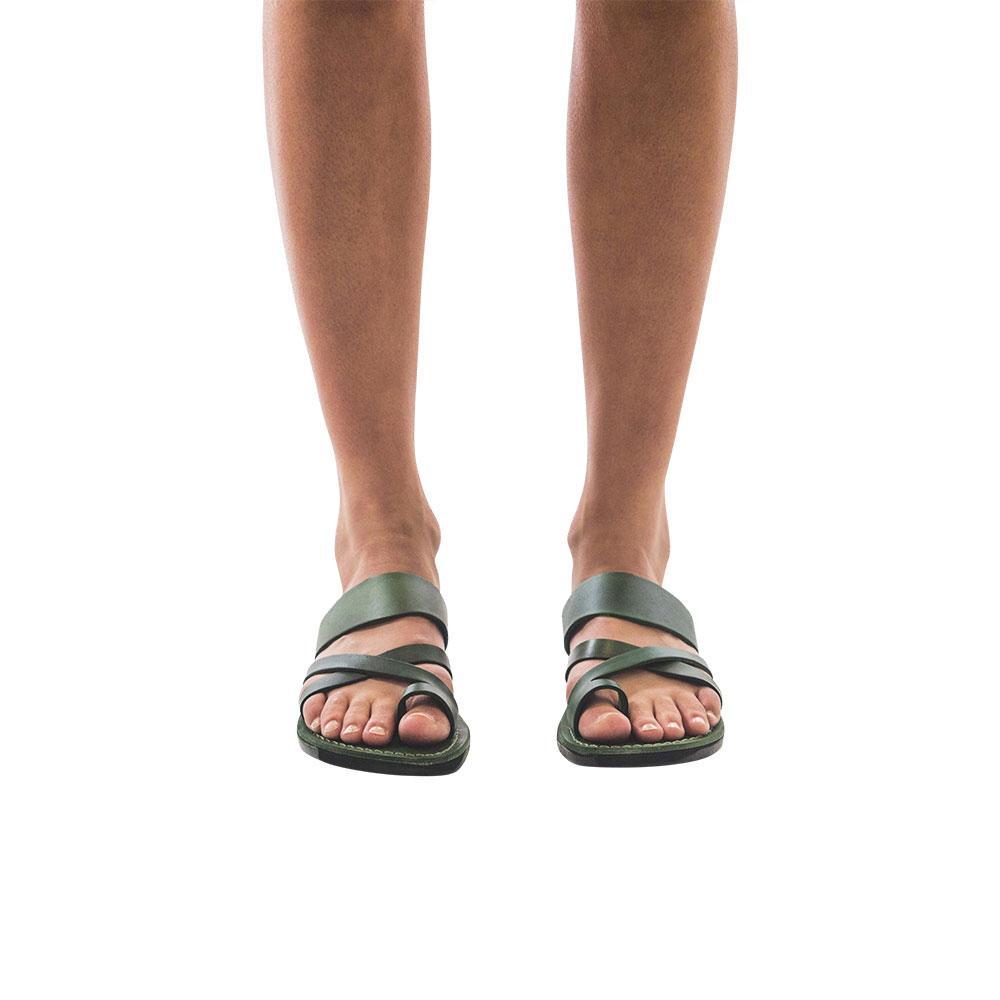 Model wearing The Good Shepherd green, handmade leather slide sandals with toe loop