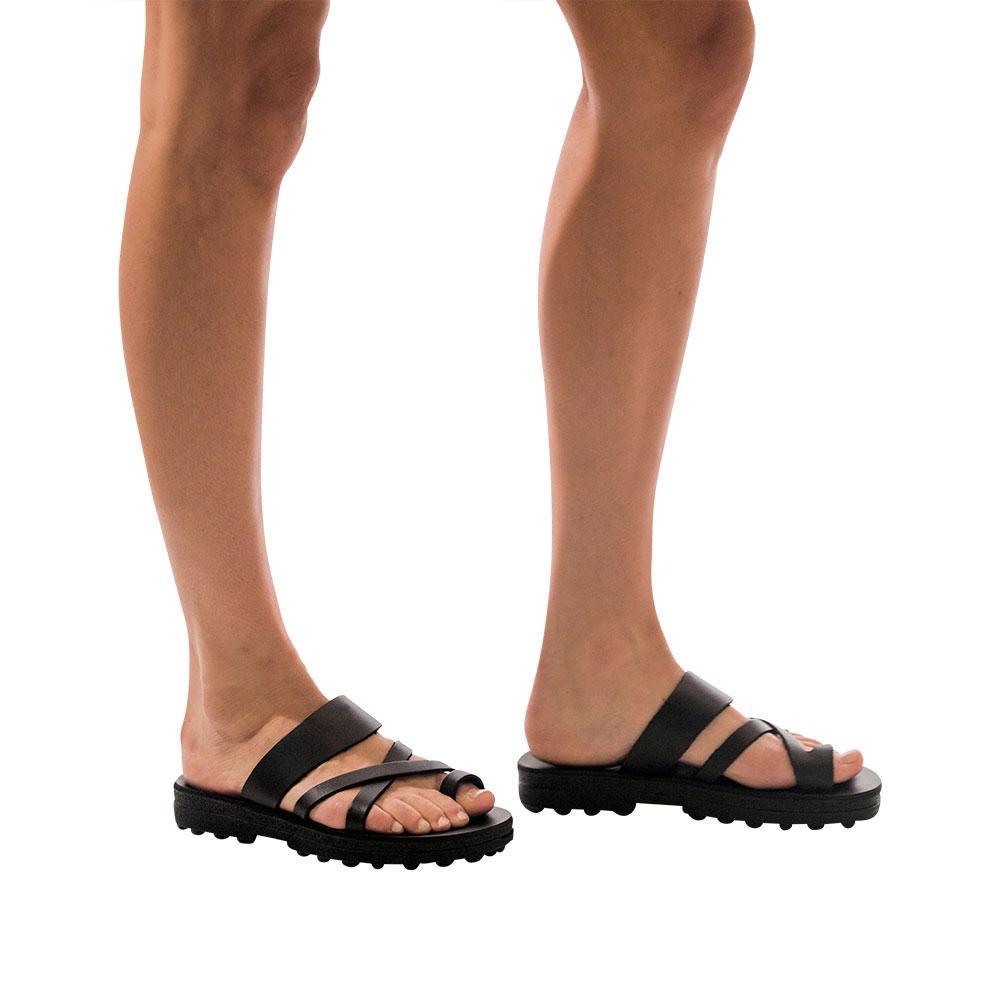 Model wearing The Good Shepherd Molded black, handmade leather slide sandals with toe loop