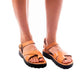 Model wearing Tovah tan, handmade leather sandals with back strap and toe loop  