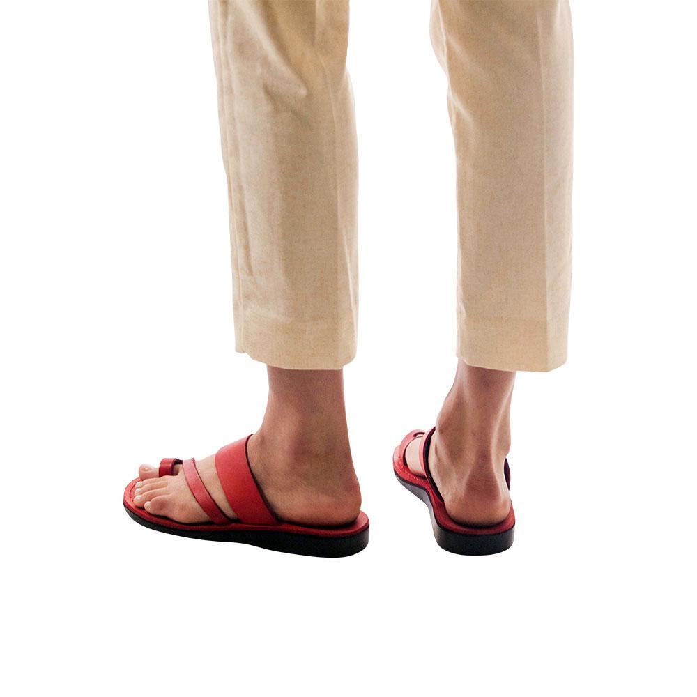 Model wearing Zohar red, handmade leather slide sandals with toe loop