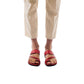 Model wearing Zohar red, handmade leather slide sandals with toe loop